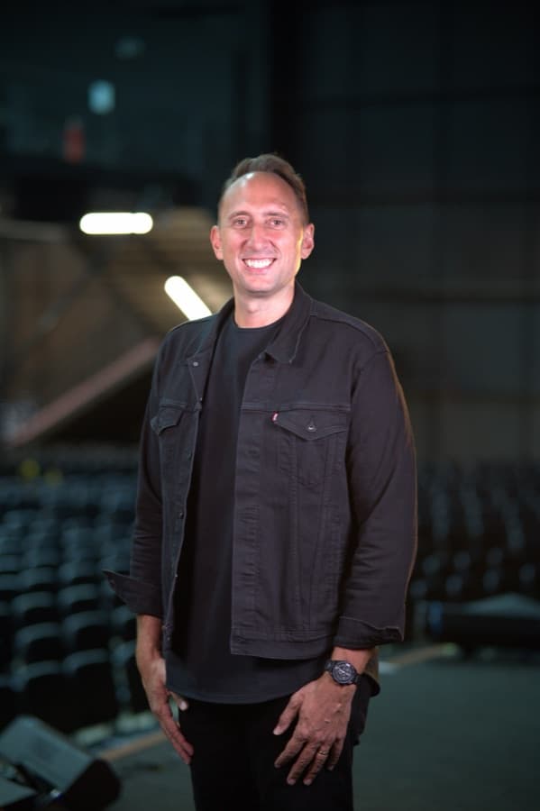 Erik Kingsley, lead pastor and founder of SermonFlow, standing in his church auditorium